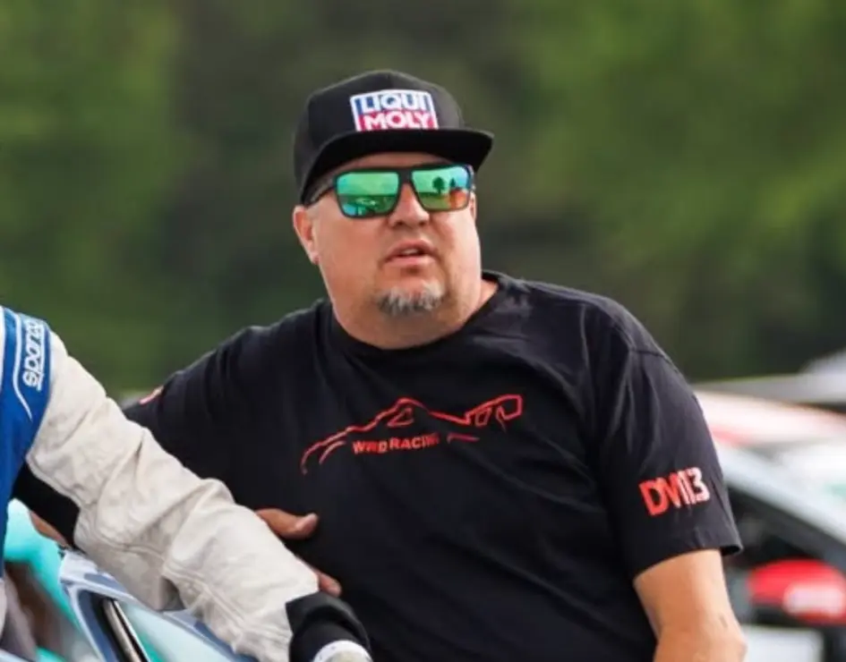 Corey Wells with KDM race cars in the paddock