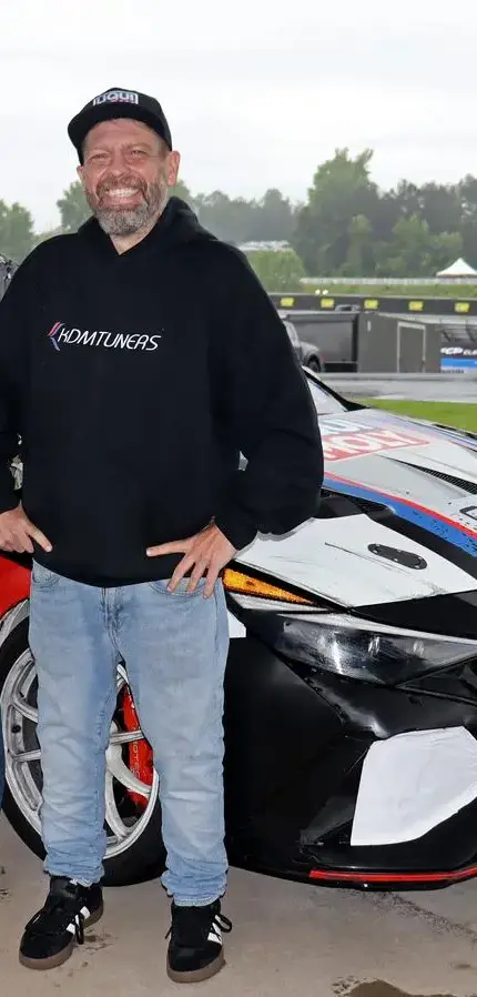 Michael Dube of SoCal N Motorsports and KDM Motorsports beside a prepared Hyundai N race car