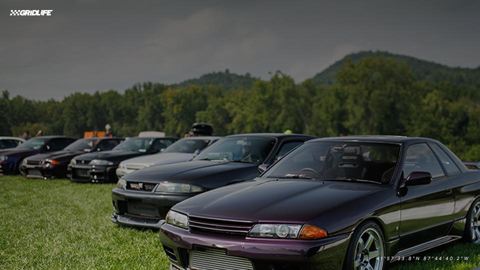 Performance cars gathered in a motorsports paddock
